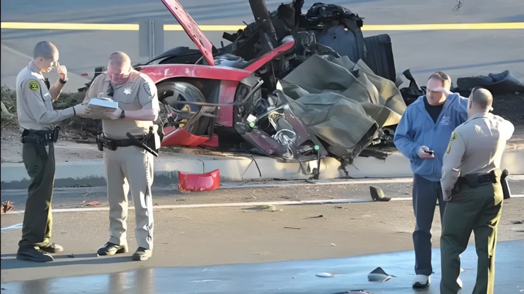 Investigators and the crashed Porsche Carrera GT car in which Paul Walker died