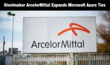 Large white outdoor corporate sign displaying the ArcelorMittal logo and name.